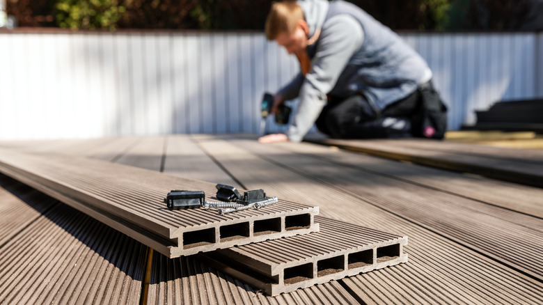 man installing composite decking