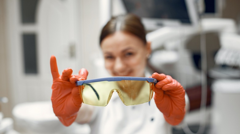 Woman holding safety goggles safety gear