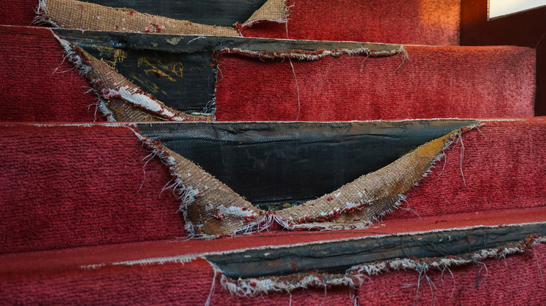 torn carpet on steps