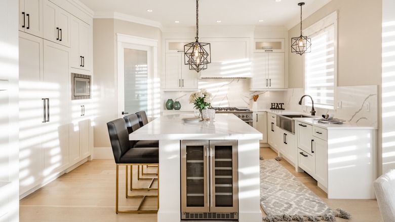 white kitchen with island pendants