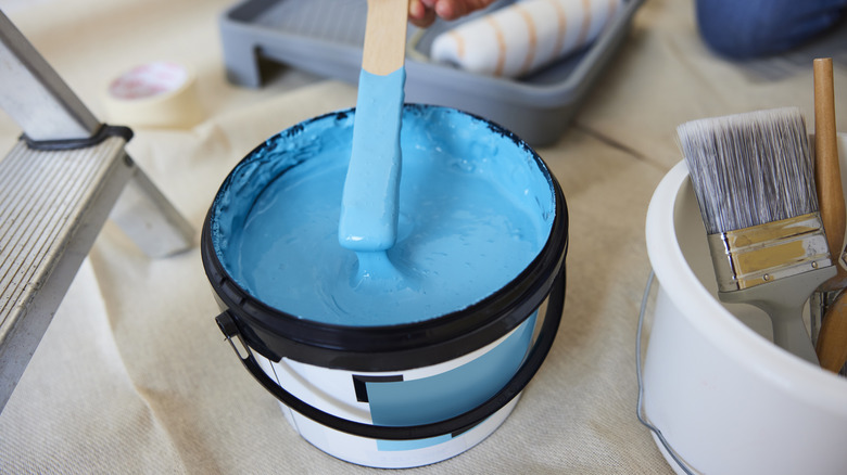 Can of bright teal paint