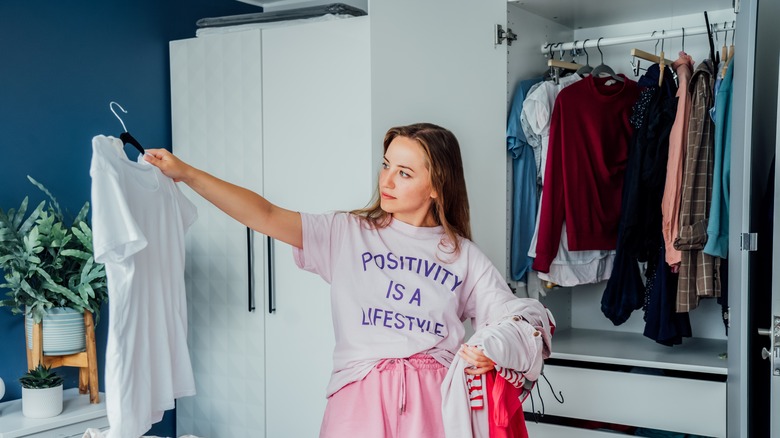 woman sorting through her closet