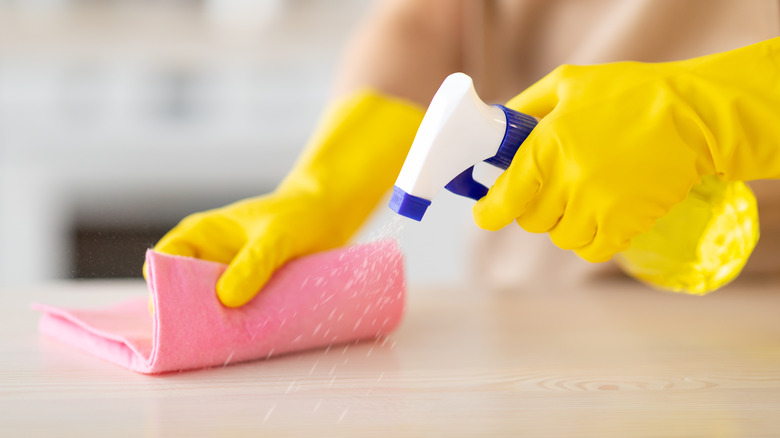 Hands cleaning laminate countertop