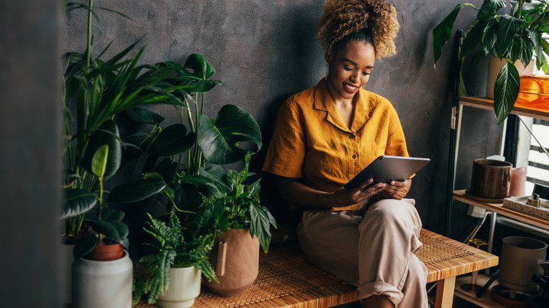 Woman research plants on tablet