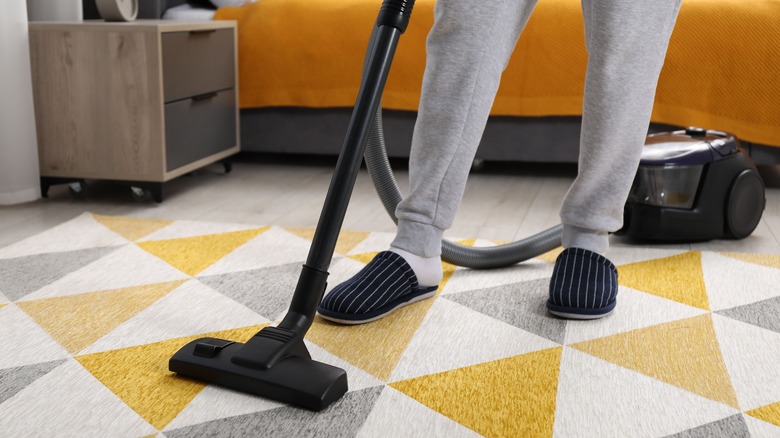 Vacuuming bedroom floor