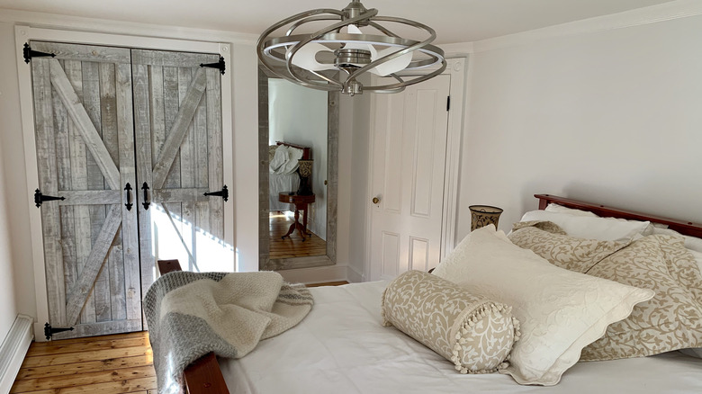 A bedroom decorated with modern farmhouse decor including a barn door