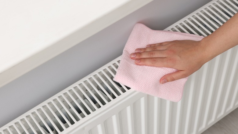 Person cleaning radiator