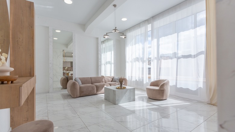 Open plan living area with shiny large format tiles