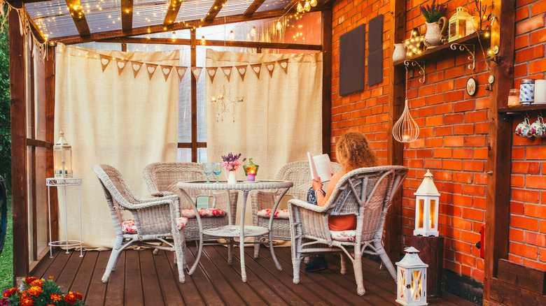 woman reading book on patio