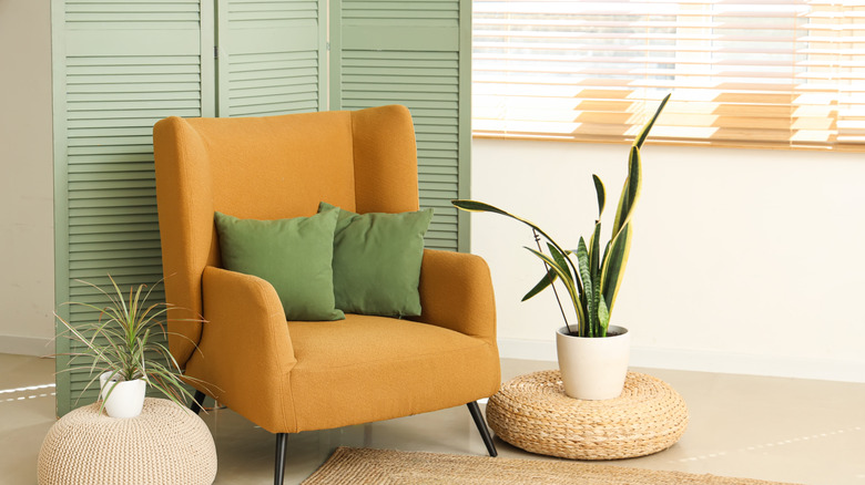 Seating area with a folding screen in front of a window