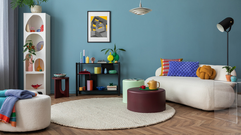 A living room with a boucle sofa and ottoman.