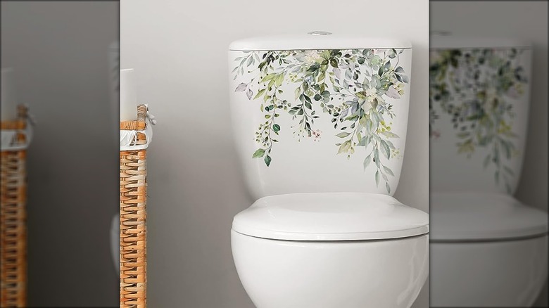 toilet with floral sticker on tank