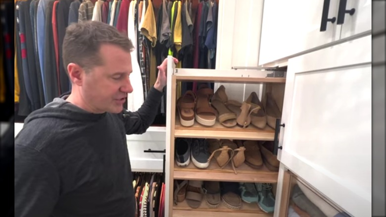 Man pulling out a vertical custom shoe rack