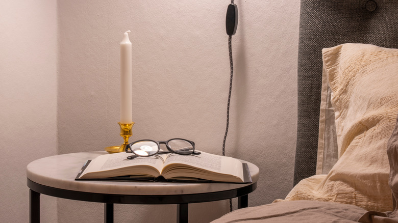 candle and book on nightstand