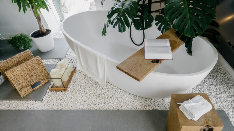 white bathtub with side table