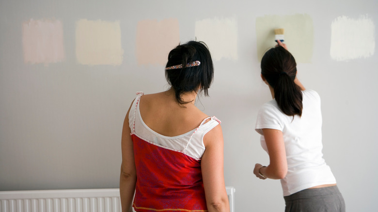 women testing different paint colors