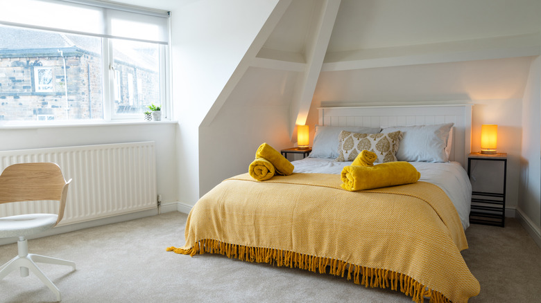 An attic bedroom has carpeting.