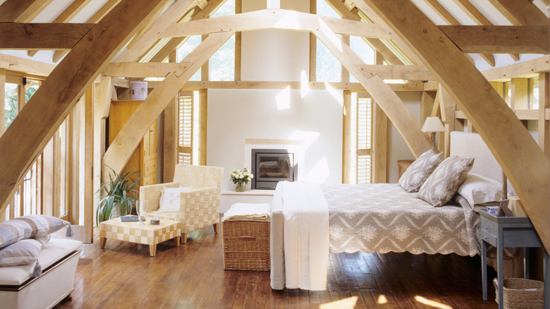 An attic bedroom has hardwood flooring.