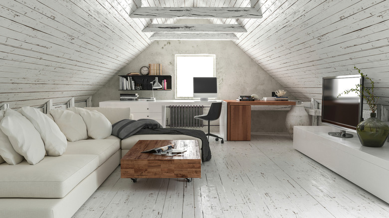 An atticl living room is shown with gray flooring.