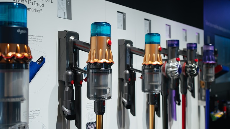 Dyson vacuums hanging on wall