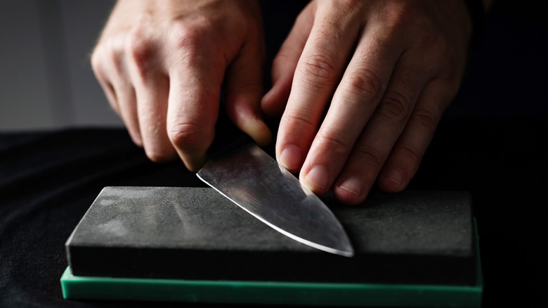 Person using sharpening stone