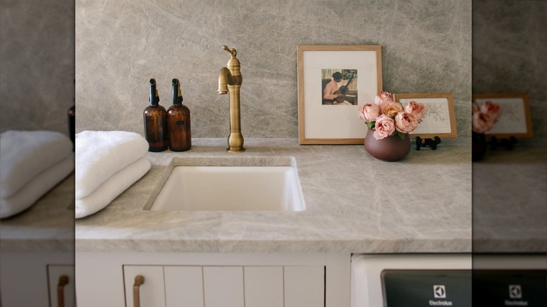 light gray leathered quartzite countertops in laundry room