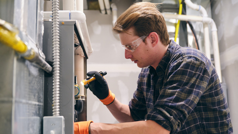 A technician working on a furnace