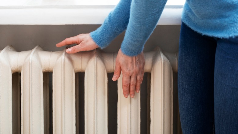 Warming hands by radiator