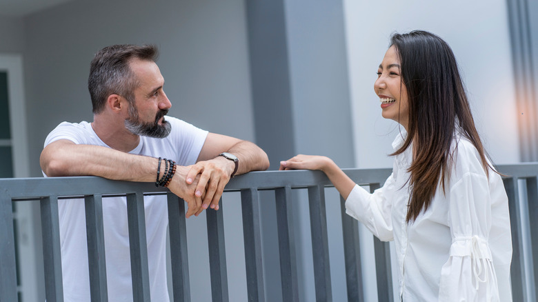 people talking over fence