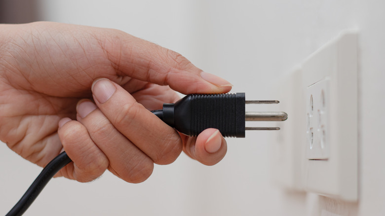 unplugged power cord on wall