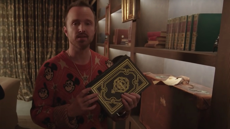 Aaron Paul with a book