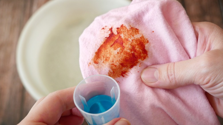 Person holding stained laundry