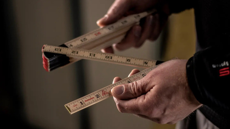 A person opening the Hultafors Tools folding ruler