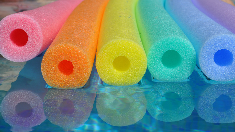 colorful pool noodles floating in a pool