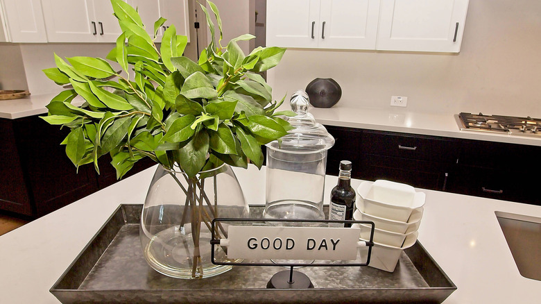 Tray on a kitchen island with decor pieces on it