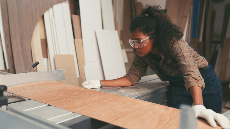 woman cutting plywood