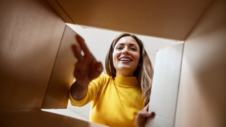 Woman reaching into cardboard box