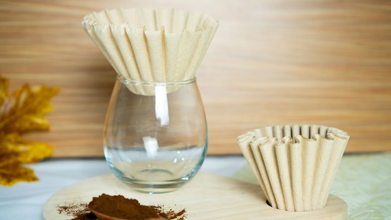 Coffee filters in vase and table