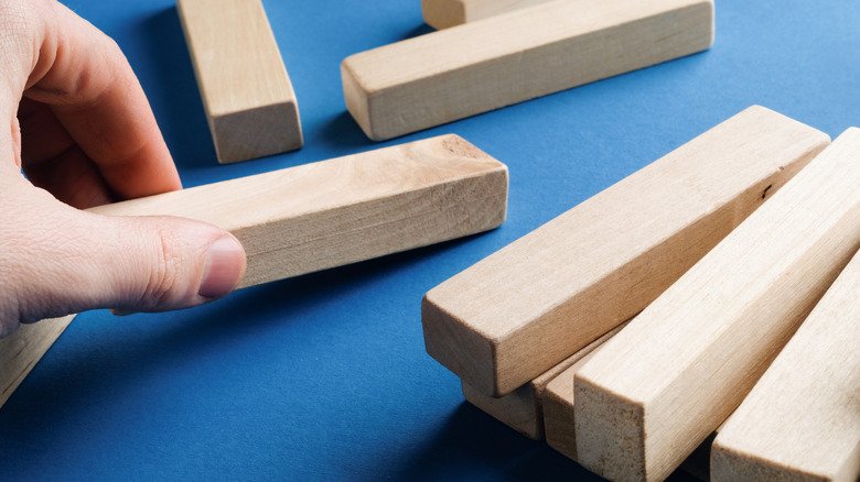 Hand moving wood game pieces