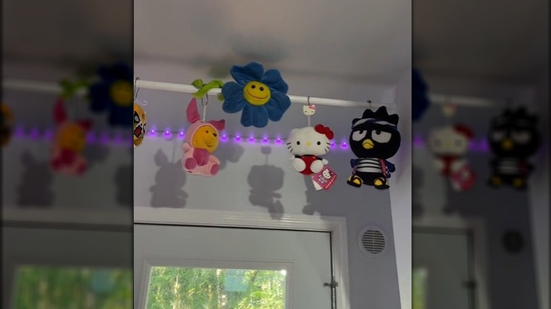 stuff animals hanging from curtain rod