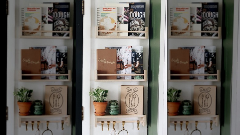 Cookbooks on spice rack shelves