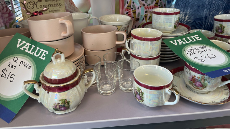 Mugs and tea cups on thrift store shelf