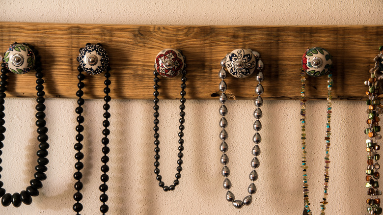 jewelry hanging on drawer knobs