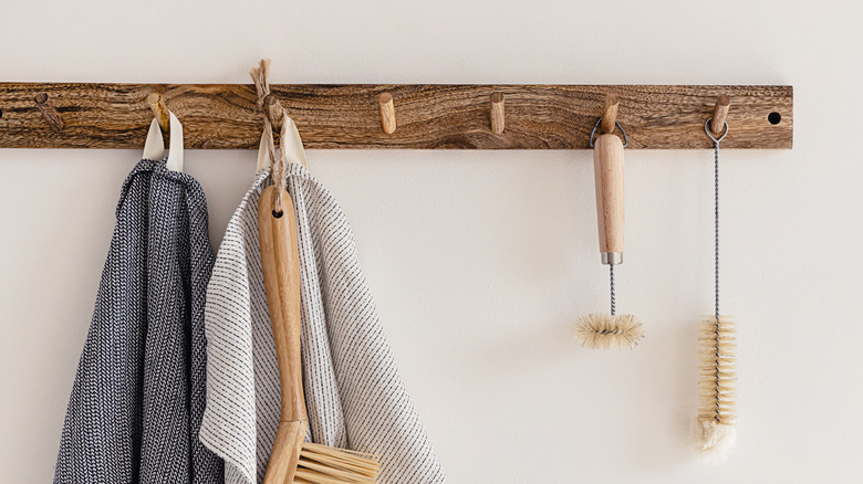 towels and brushes on wood rack