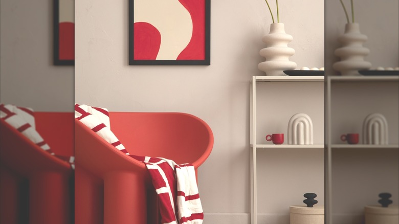 A red mid-century modern chair in a modern room