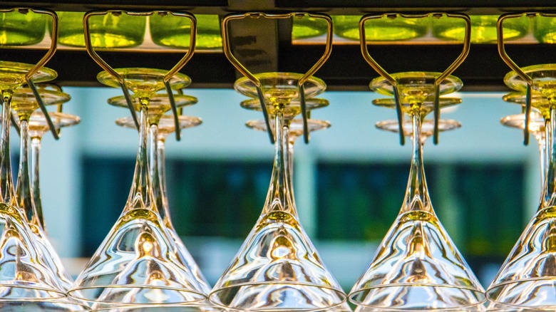 Martini glasses hanging from rack