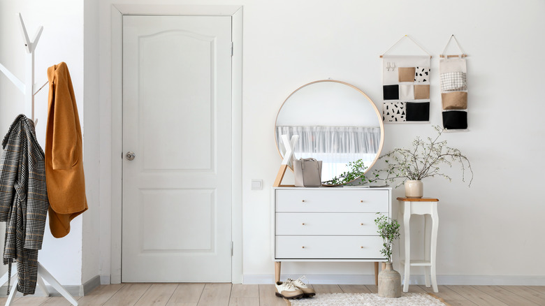 chic foyer, all white walls and decor