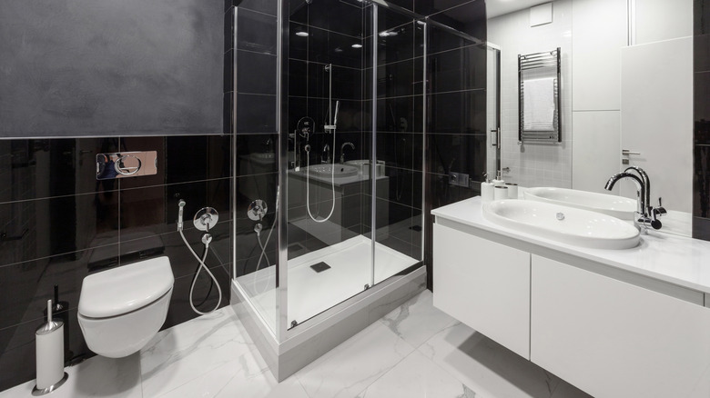 Bathroom with large tiles, toilet, sink and shower