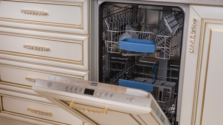 A hidden dishwasher within ornate beige panels