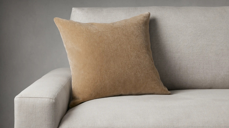 A mohair pillow on a grey couch